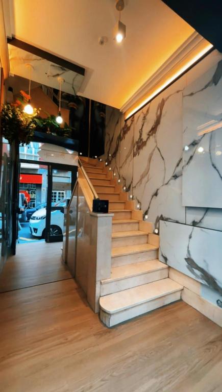 a staircase in a building with a stone wall at Hotel Hito in Vitoria-Gasteiz