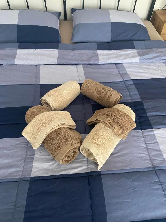 a bed with three rolled up towels on it at Wellness Varaždin in Varaždin