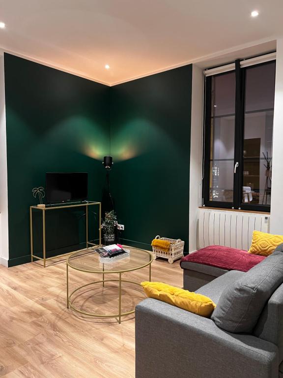 a living room with a couch and a glass table at L'arquebuse - Gare Dijon in Dijon