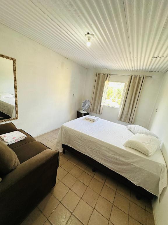 a hotel room with a bed and a couch at Residência Central Triunfo-PE in Triunfo