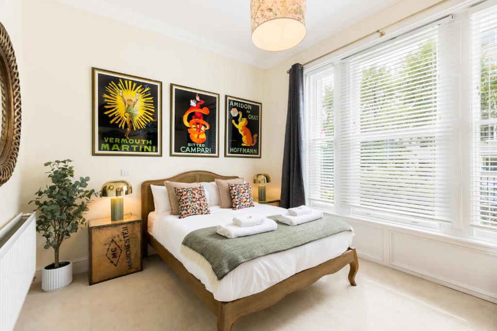 a bedroom with a bed and a window at Maitland House Boutique Apartment in Gloucestershire