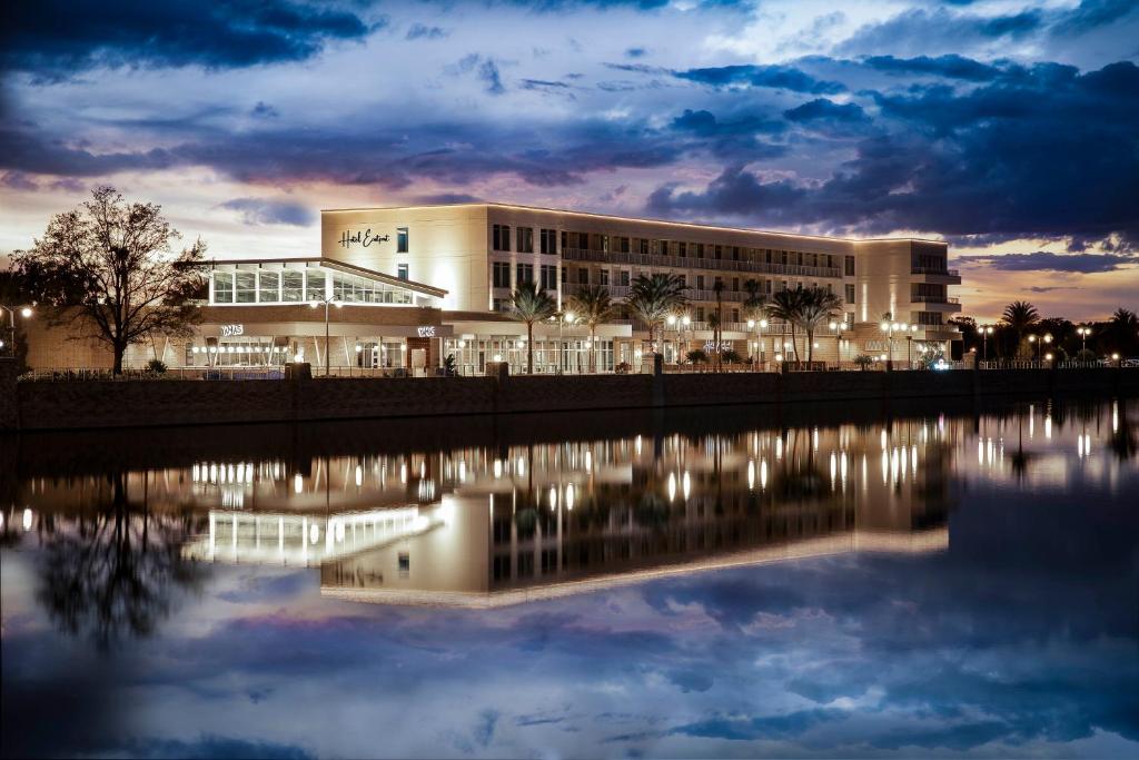 a building at night with its reflection in the water at Hotel Eastport in The Villages