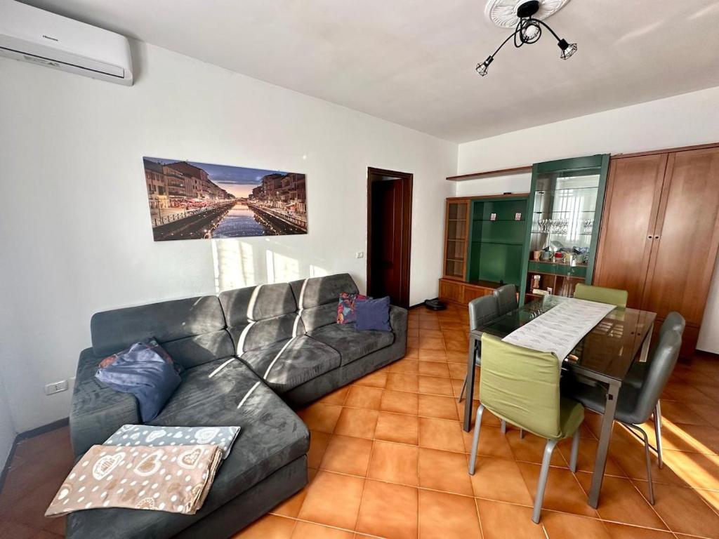 a living room with a couch and a table at Ziva's house apartment in Abbiategrasso in Abbiategrasso