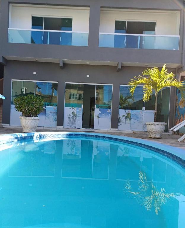 a large swimming pool in front of a building at Flat Ubarana Maragogi-AL in Maragogi