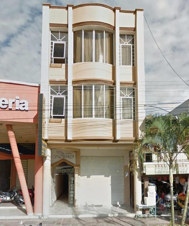 a tall building with a store at Hotel Victoria in Nueva Loja