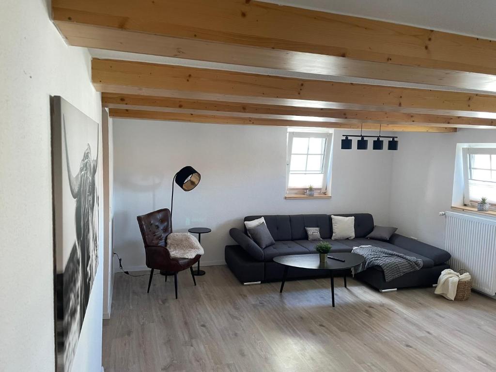 a living room with a couch and a table at Ferienwohnung Holtensen in Göttingen