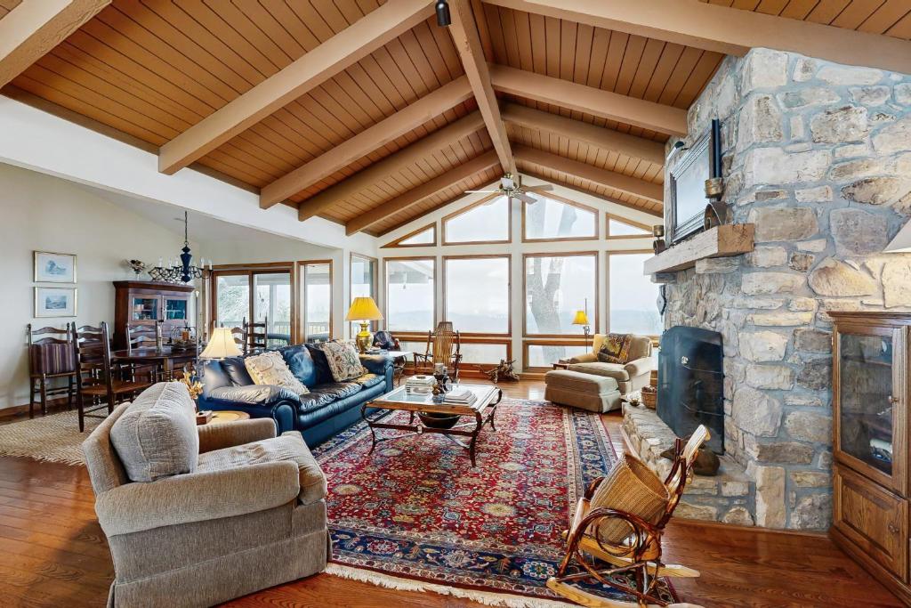 a large living room with a large stone fireplace at Peaks & Pines Escape in Beech Mountain