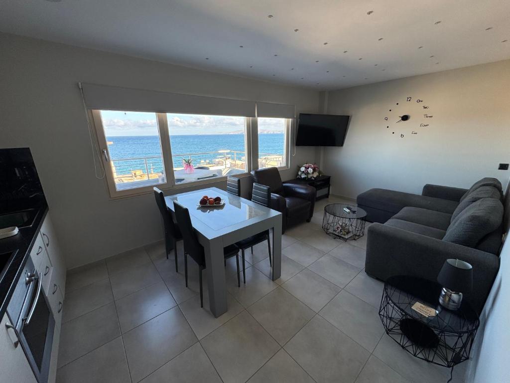 a living room with a couch and a table at MAXIM APARTMENT in Heraklio