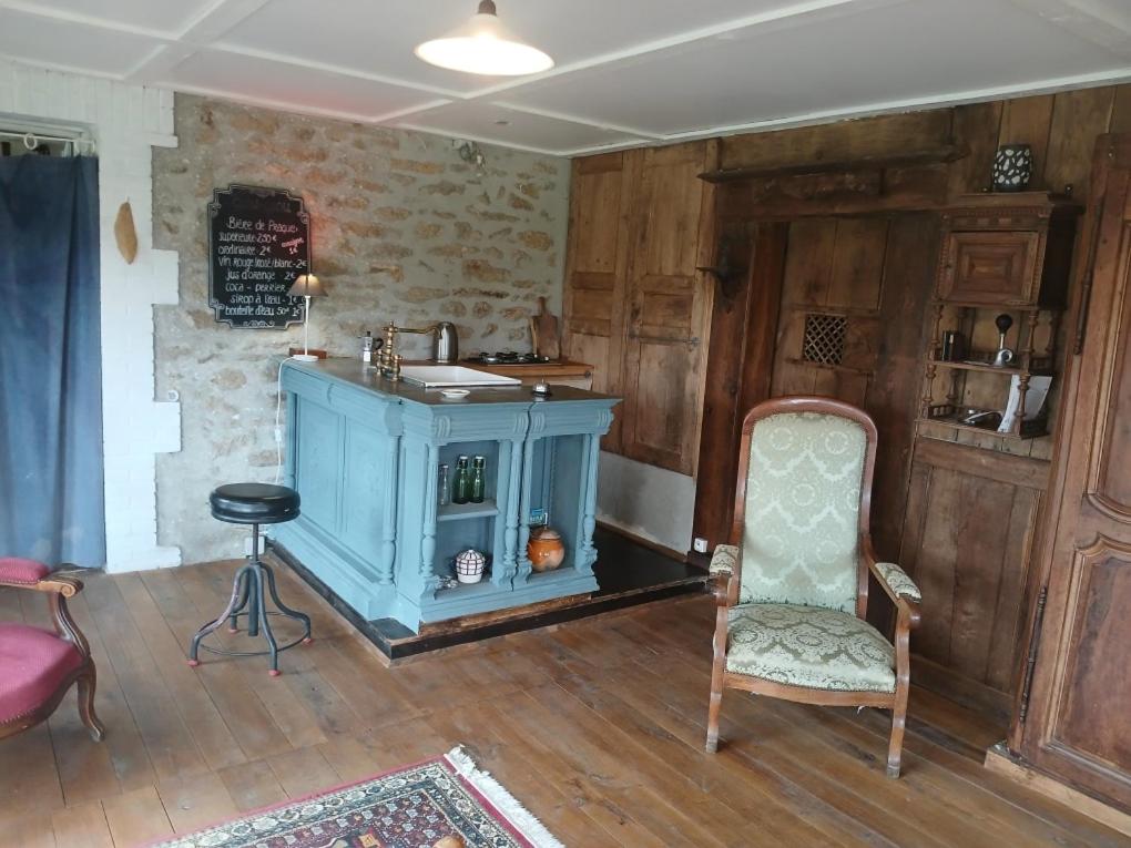 a room with a blue cabinet and a chair at Charme en pleine nature in Thauron