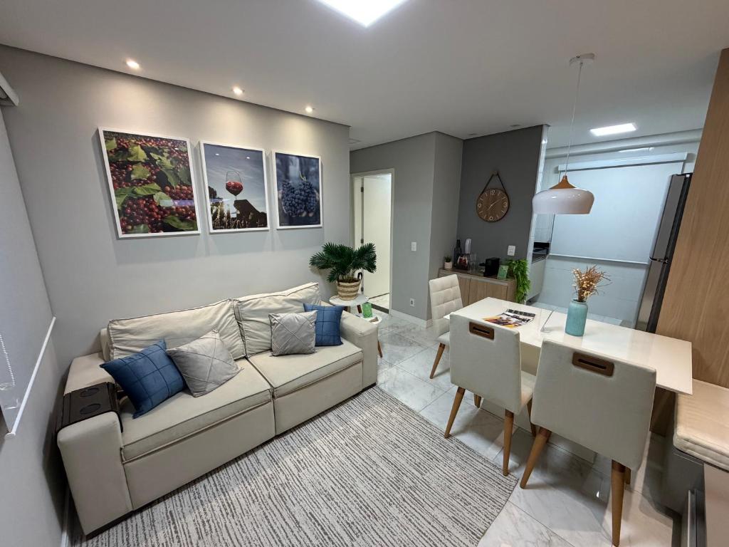 a living room with a couch and a table at Recanto das Colinas II in Espirito Santo Do Pinhal