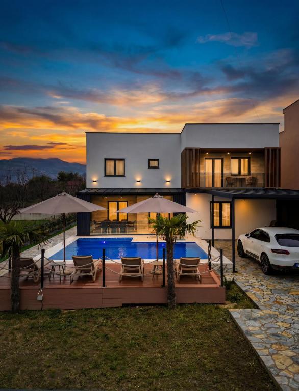 a house with a swimming pool in front of it at Luxury Villa Bar in Bar