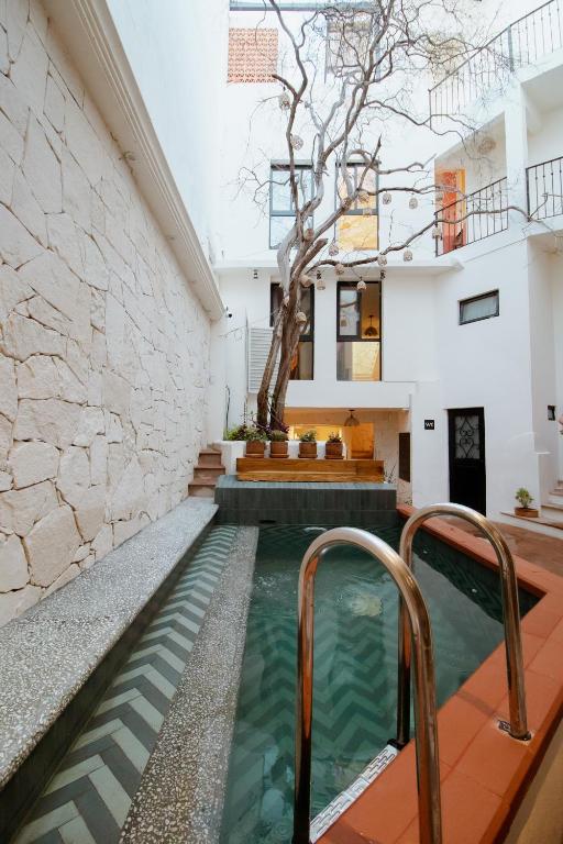 a pool in the middle of a house with a tree at Bernardino Boutique Hotel in Guanajuato