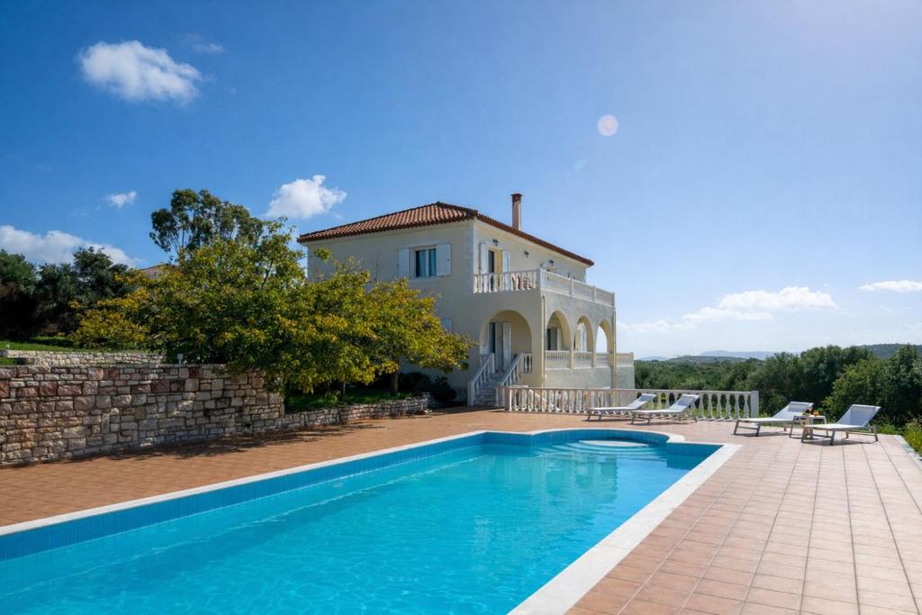 an external view of a villa with a swimming pool at Villa Aether Methoni in Methoni