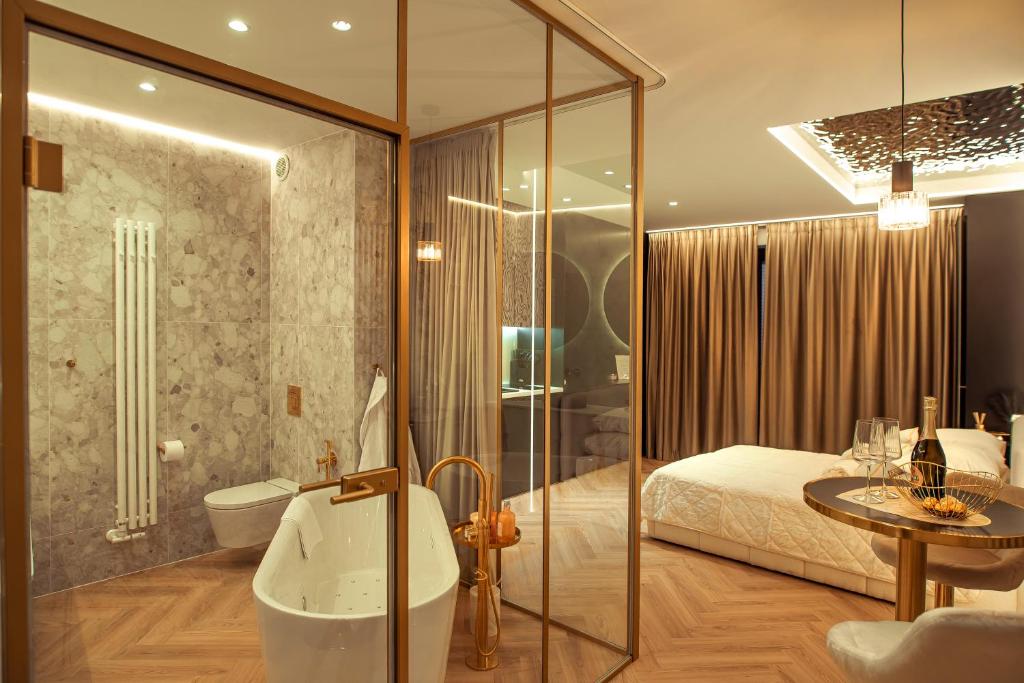 a bathroom with a tub and a bedroom with a bed at Gdańsk Luxury Stay Jacuzzi in Gdańsk