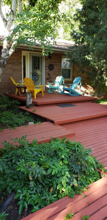 a deck with chairs and a table and chairs on a house at Beautiful Country Location in Harrisville