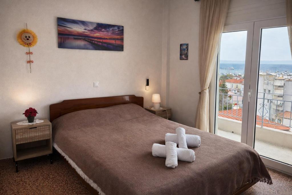 a bedroom with a bed with white towels on it at Your refuge overlooking port 6A in Mytilene
