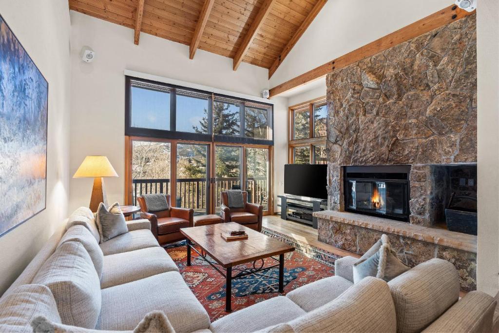 a living room with a couch and a fireplace at Ridge 27 in Snowmass Village