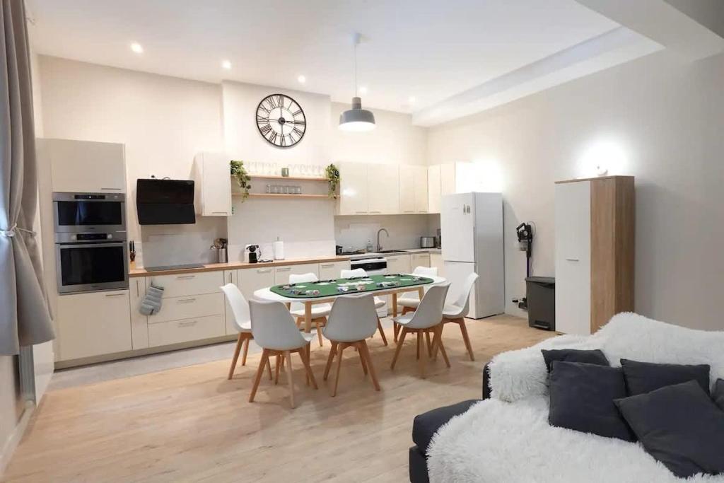 a kitchen and a living room with a table and chairs at L'As d'Aubert - 8 pers - Centre in Arras