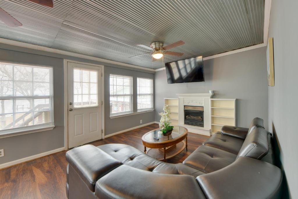 a living room with a leather couch and a tv at Lake Views + Dock Access: Georgetown Group Getaway in Georgetown