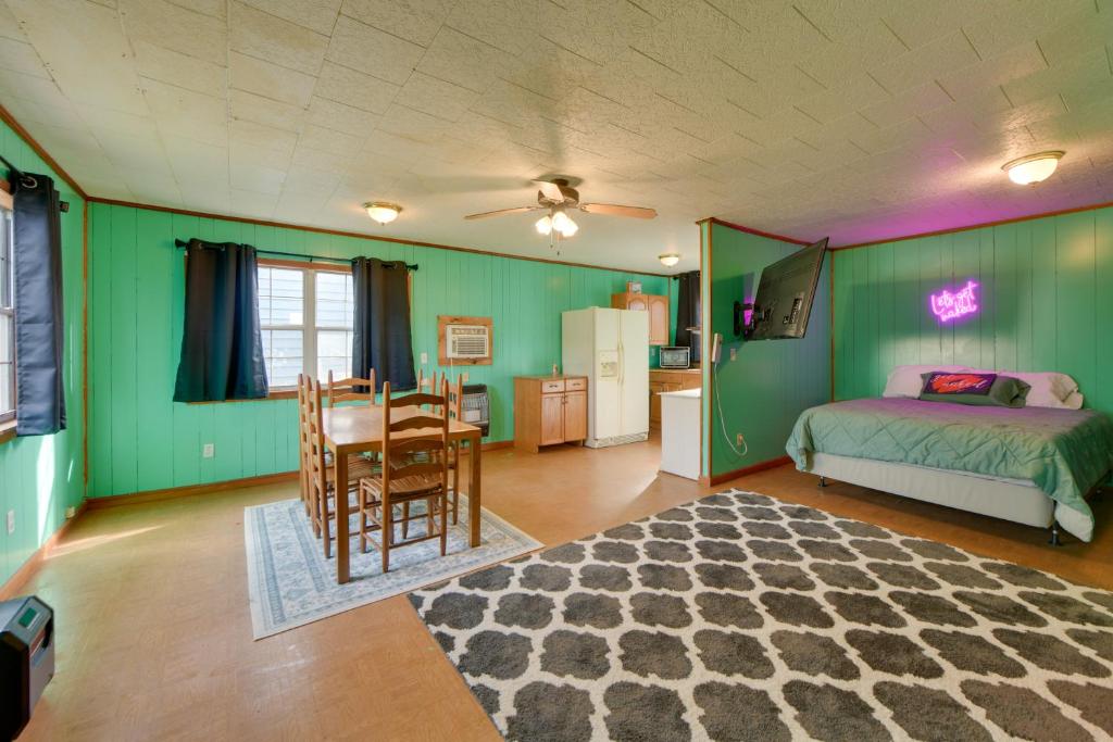 a bedroom with green walls and a table and a bed at Couple’s Retreat w/ Dock Access on Lake Eufaula! in Georgetown