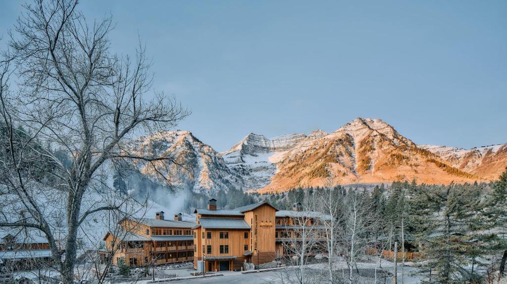a building in the snow with mountains in the background at Sundance Mountain Resort in Sundance