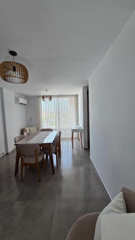 a living room with a dining table and chairs at Departamento BARBÚ in Villa María