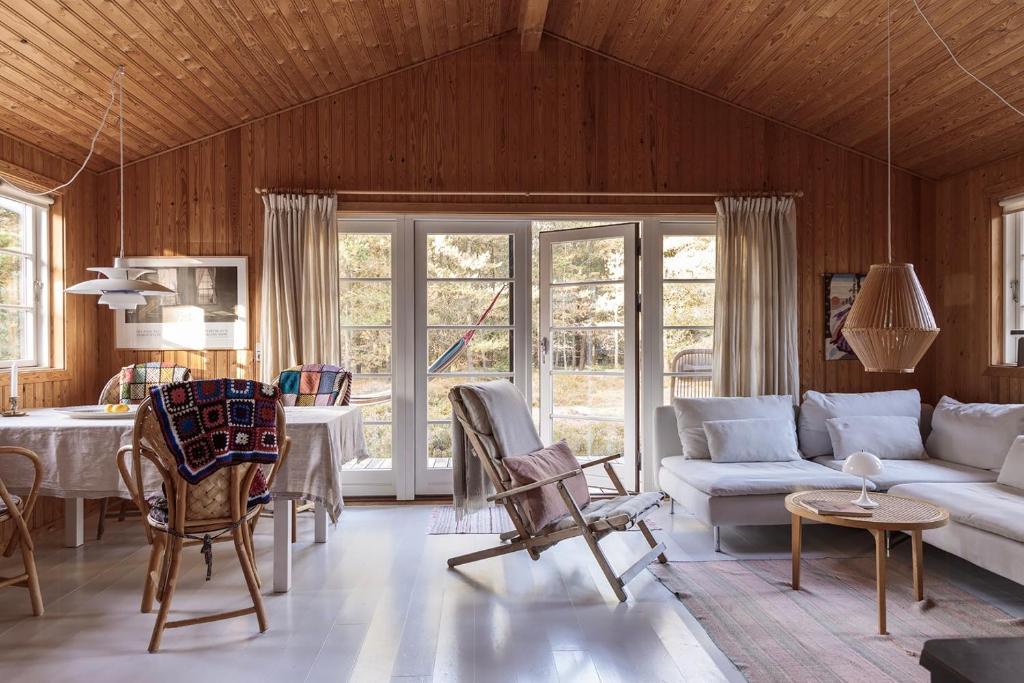 a living room with a couch and a table at Authentic Summerhouse Near The Beach in Rørvig