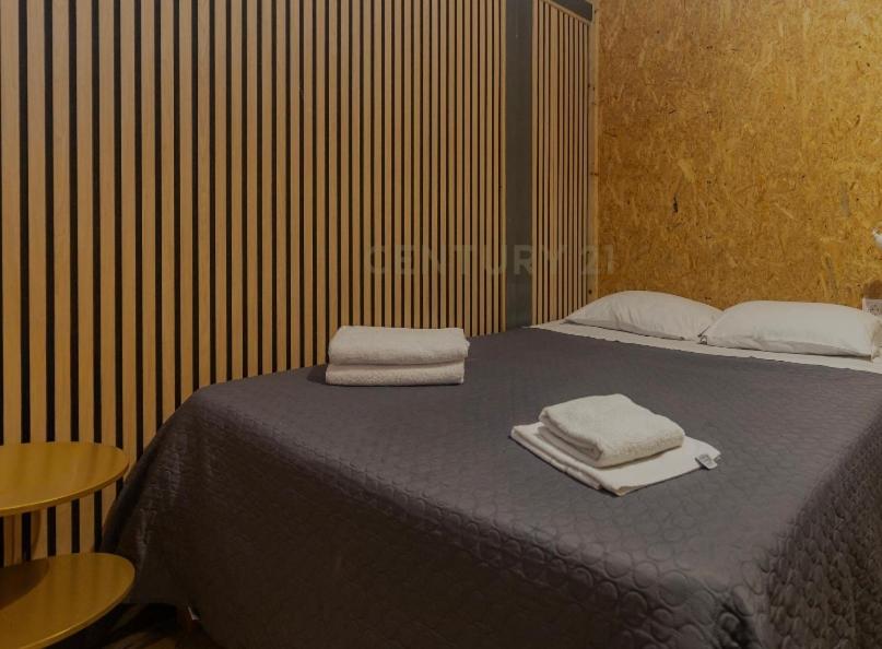 a bedroom with a bed with two towels on it at Portela Room in Carnaxide