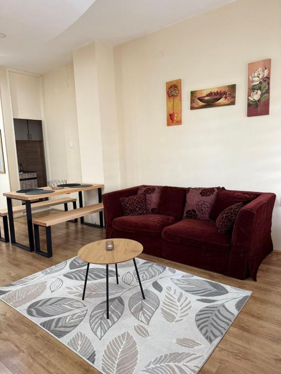 a living room with a couch and a table at Apartman Milica in Kremna