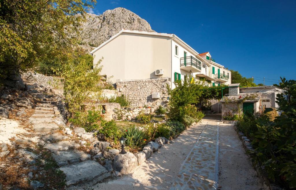 a house on the side of a mountain at Holiday Home Alegra in Podgora