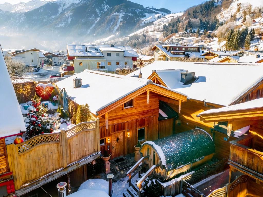 a winter view of a town with snow covered roofs at Adventure Lodge Kaprun in Kaprun