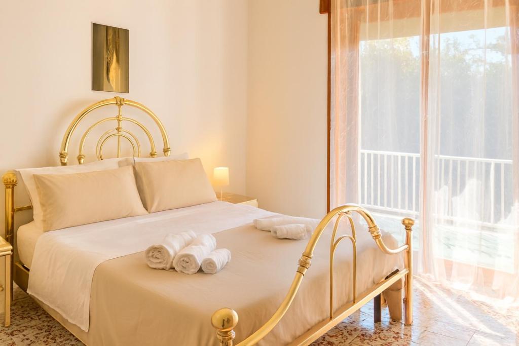 a bedroom with a bed with towels on it at Exclusive Large 3 bed room Apartment with Pool Central Sorrento in Sorrento