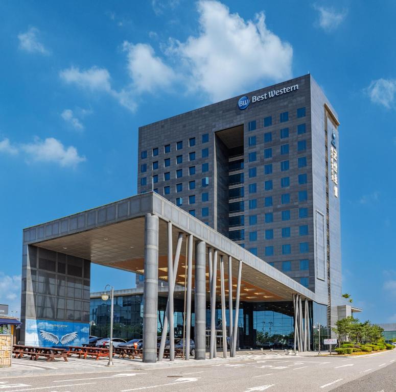 a tall building with a sign on the front of it at Best Western Hotel Gunsan in Gunsan-si