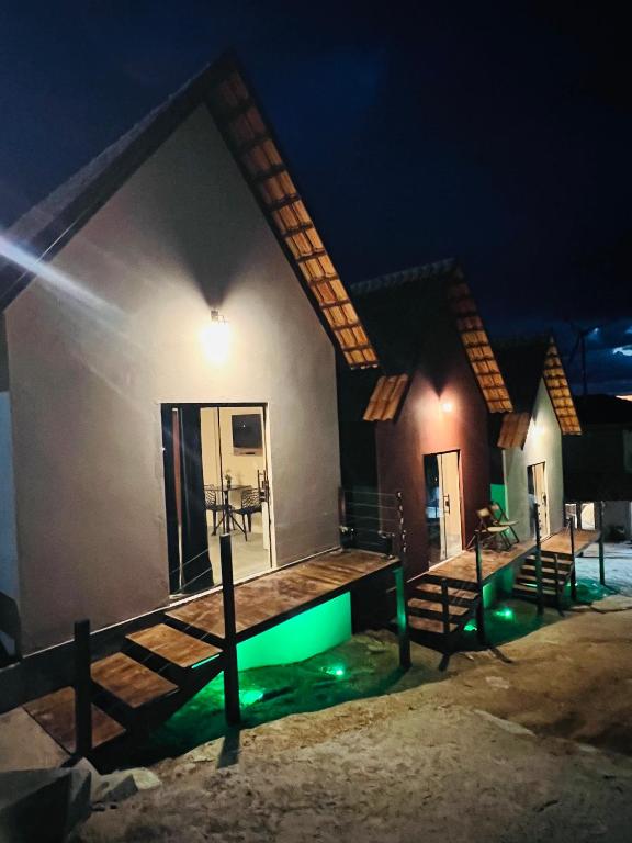 a house with a swimming pool at night at Margarida 02 in Monte das Gameleiras