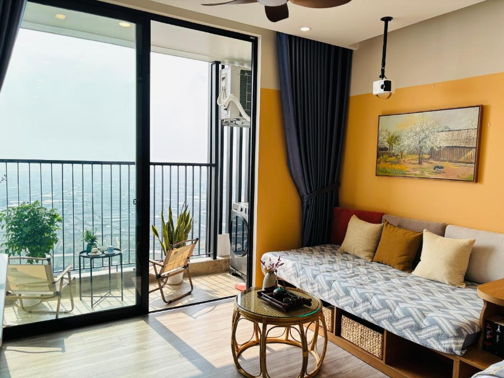 a living room with a couch and a balcony at Măng Homestay in Kim Quan