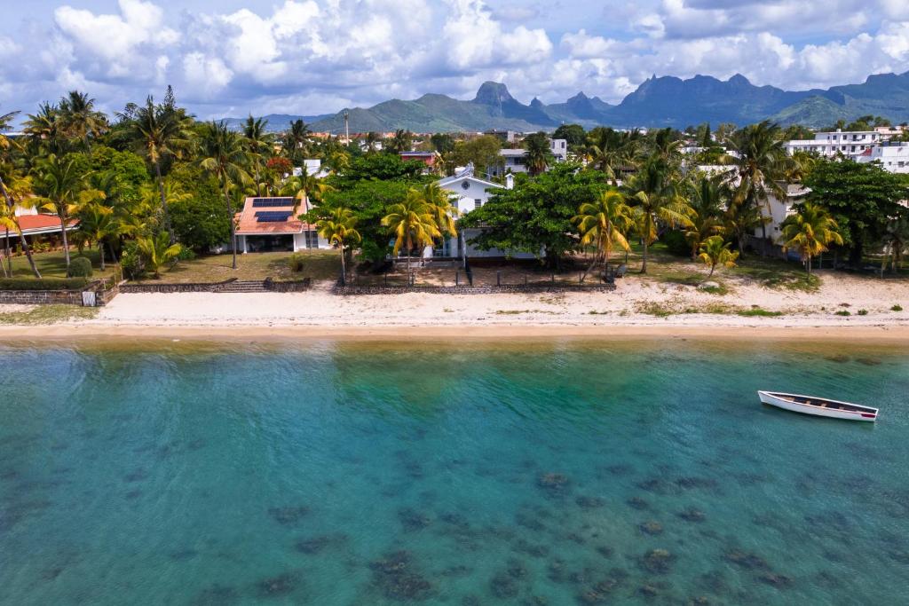 a boat in the water next to a beach at Amarea Beach Front Appartment or Studio in Richeterre