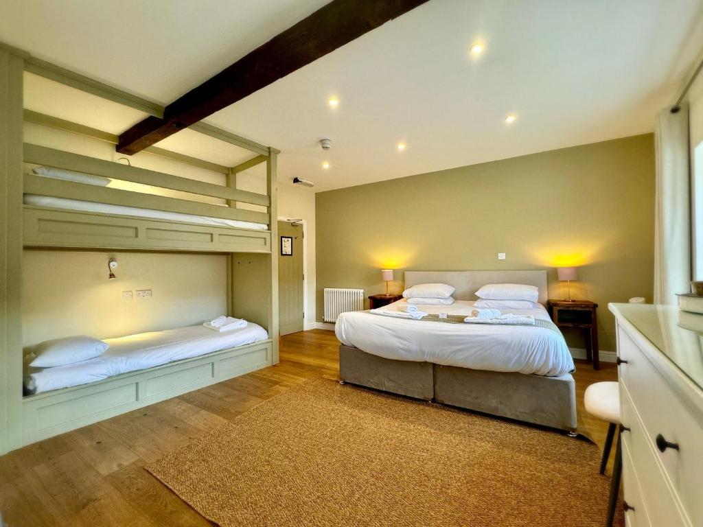 a bedroom with two beds and a large window at RIVERBANC in Llangollen