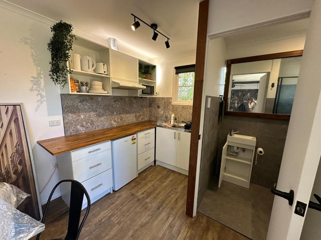 a small kitchen with white cabinets and a sink at Guest House in East Devonport in Devonport