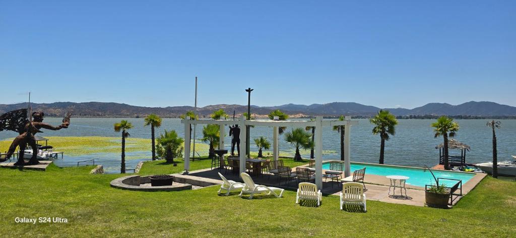 a man is playing guitar next to a swimming pool at Casa Lago Rapel in Las Cabras