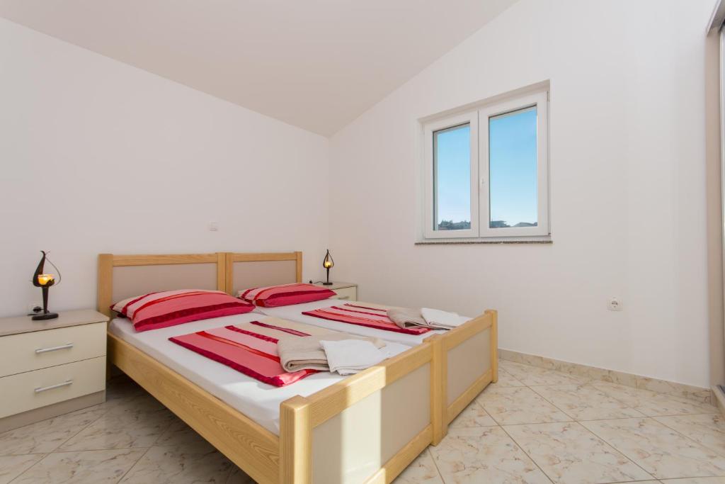 Posteľ alebo postele v izbe v ubytovaní Apartments Jaman Ivan