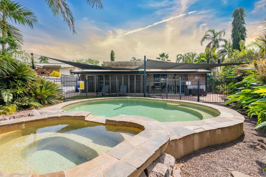 a swimming pool in the backyard of a house at Nature's Nest - Pool - SPA - Outdoor Kitchen and Dining in Leanyer