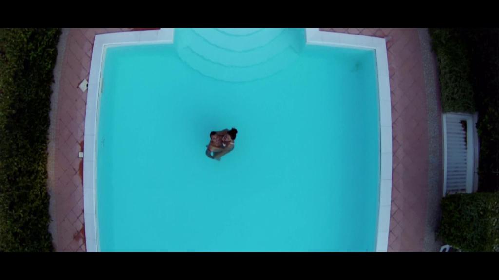 a butterfly sitting on top of a blue door at Hotel Levante in Fossacesia