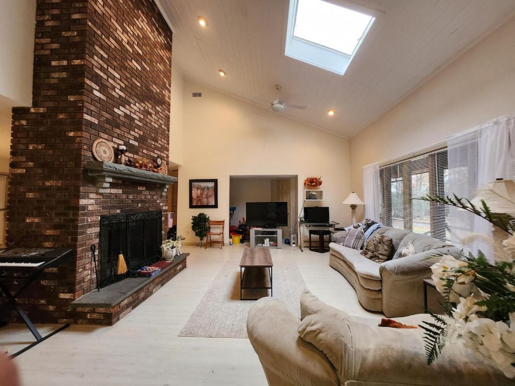 a living room with a couch and a fireplace at Eagles Nest Mansion in Montgomery