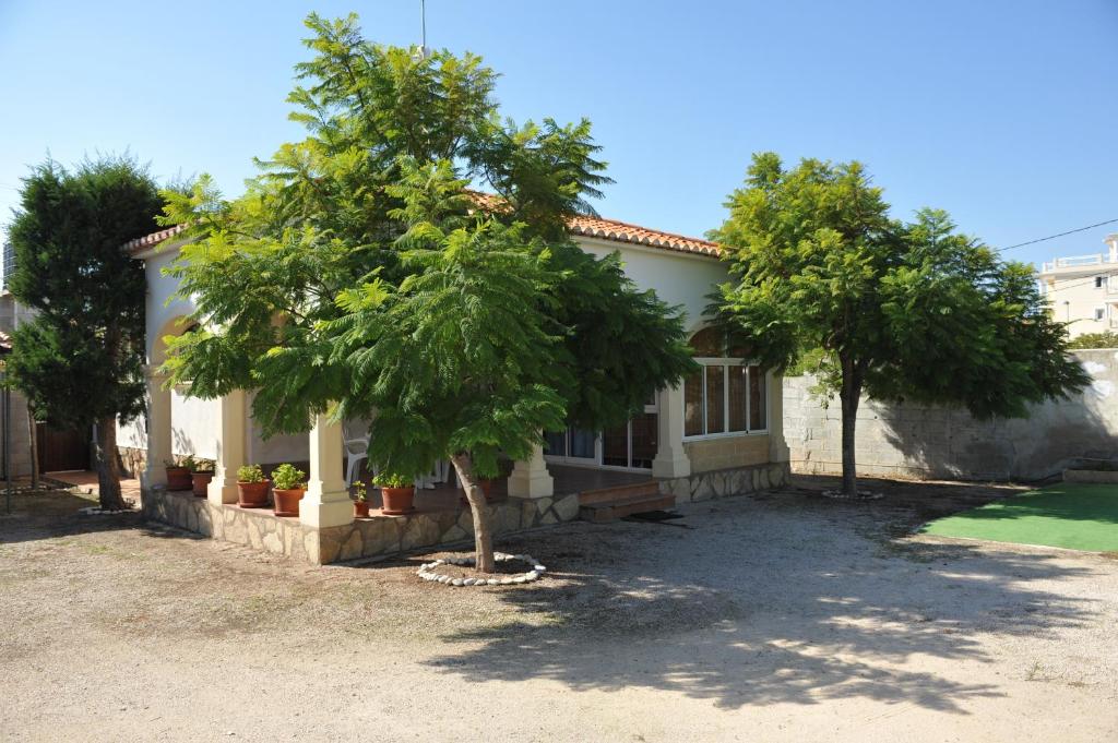 a house with two trees in front of it at The House in Casas Devesa