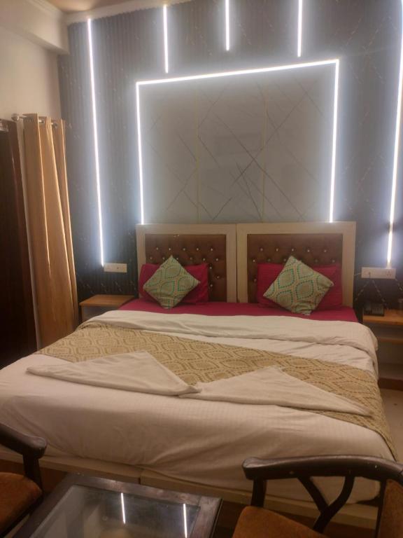 a bed with a headboard and pillows in a room at Tapovan Lightning room by yog tapovan in Rishīkesh