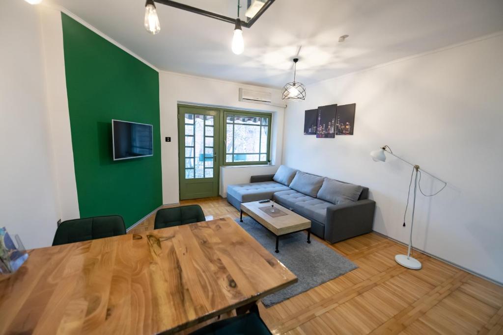a living room with a table and a couch at Srafko apartment in Subotica