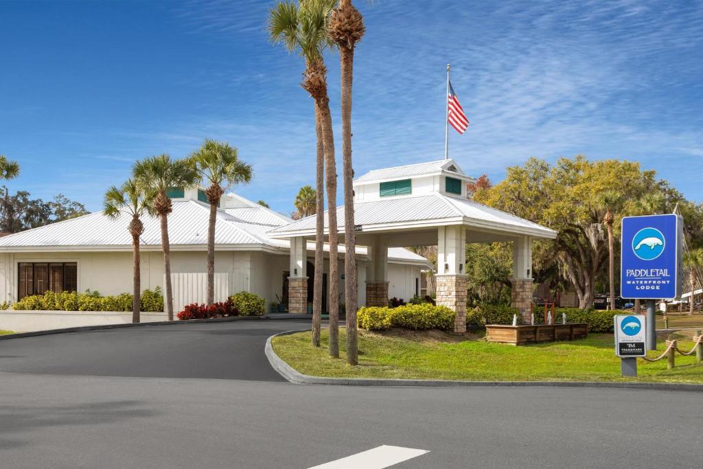 a house with an american flag on top of it at PaddleTail Waterfront Lodge, Trademark Collection by Wyndham in Crystal River