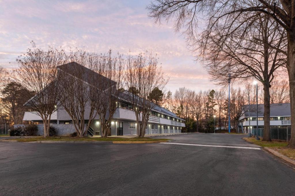 an empty street in front of a building at Days Inn by Wyndham Charlotte University in Charlotte