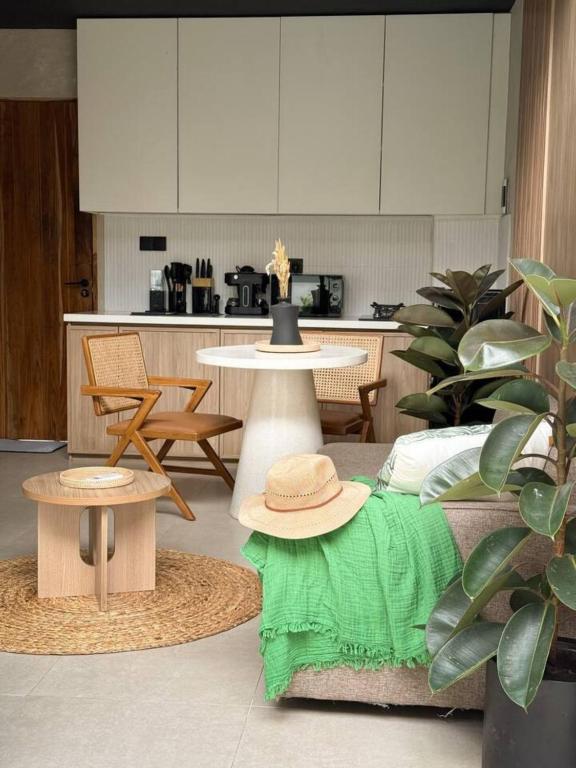 a living room with a table with a hat on it at NOMAD Chic Private Pool Loft in Canggu, all inclusive stay in Dalung