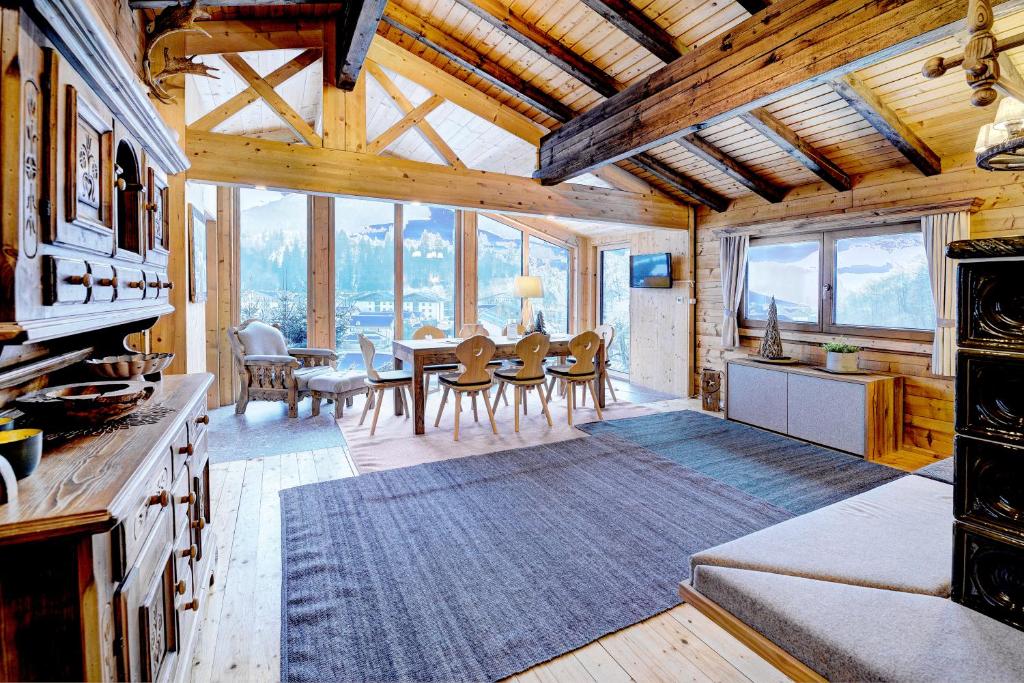 a kitchen and dining room with a table and chairs at Ferienhaus Gasteg in Maria Alm am Steinernen Meer